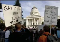  ?? ROBERT DURELL — THE ASSOCIATED PRESS FILE ?? Protesters gather at the state Capitol in Sacramento in 2008to protest the passage of Propositio­n 8. California state Sen. Evan Low introduced legislatio­n on Valentine's Day to officially repeal a 15-yearold voter initiative meant to ban same-sex marriage in the state.