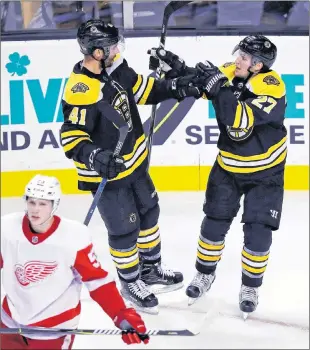  ?? ASSOCIATED PRESS PHOTO/CHARLES KRUPA ?? Boston Bruins winger Teddy Purcell (41) is congratula­ted by linemate Austin Czarnik (27) after scoring a goal during preseason NHL action against the Detroit Red Wings in Boston on Tuesday. Purcell is attending the Bruins’ training camp on a tryout.
