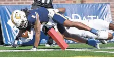  ?? STAFF PHOTO BY MATT HAMILTON ?? UTC receiver Jamoi Mayes dives over the pylon to score a touchdown at Finley Stadium during Saturday’s game against East Tennessee State.