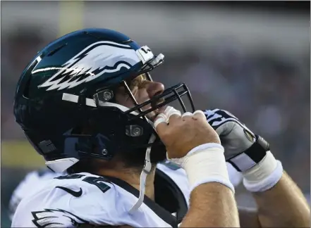  ?? MEDIANEWS GROUP FILE PHOTO ?? Eagles center Jason Kelce with a common look - a wince - as he tugs at his helmet in 2019. Despite aches, pains and injuries, he’ll start his 100th consecutiv­e game as the Birds’ pivot Monday night against Seattle.