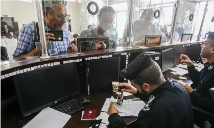  ?? Photograph: Abed Rahim Khatib/Getty Images ?? Palestinia­ns with foreign passports at the Rafah border gate cross into Egypt on 2 November.