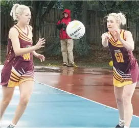  ??  ?? Left: Ebony Mumford passes to teammate Stacie Gardiner during Drouin A grade’s seven-goal win over Maffra on Saturday.
Far left: Drouin’s Kelly Hedley passes on the goal circle in the A grade game. Defending is Maffra opponent Emma Allman. After a...