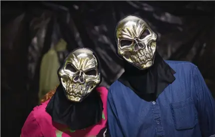  ?? PHOTOS BY KELVIN GREEN/THREE RIVERS EDITION ?? Volunteers Suzanne Magouryk, left, and David Thompson show off their masks at the Darkness Haunted House in Batesville. The haunted house to benefit Main Street Batesville will be open from 7-10 p.m. Oct. 13-14, 20-21, 27-28 and 30-31.