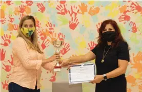  ??  ?? Award of winning trophy and certificat­e: Greta Antignolo (current president) and Audrey Galea (head of School, Our Lady Immaculate School, Hamrun)