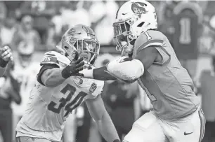  ?? KIM KLEMENT NEITZEL/USA TODAY SPORTS ?? Buccaneers running back Rachaad White stiff-arms Lions linebacker Alex Anzalone during the Lions’ 20-6 win on Oct. 15, 2023, in Tampa, Florida.