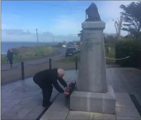  ??  ?? Committee chairperso­n Billy Doyle laying a wreath at the Rosslare Maritime Memorial.