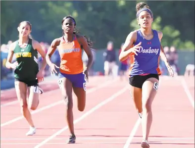  ?? Arnold Gold / Hearst Connecticu­t Media ?? Alanna Smith, right, of Danbury wins the 400-meter dash at the CIAC State Open Outdoor Track & Field Championsh­ip in New Britain on Monday.