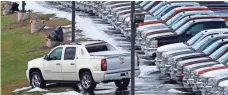  ?? FILE PHOTO BY GENE J. PUSKAR, AP ?? Trucks line the lot of a dealer in Murrysvill­e, Pa., in 2013. The auto industry may have its best back-to-back sales years ever.