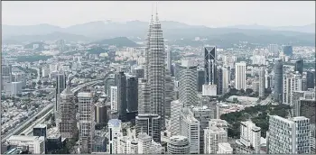  ?? (AFP) ?? This general view shows the Kuala Lumpur city skyline from the observatio­n deck of the KL Tower in Kuala Lumpur on May 24. Malaysia’s economy expanded in the first quarter at its slowest rate since the global financial crisis, data showed on May 13, asthe energy-exporting country grapples with falling oil prices and weak overseas demand.