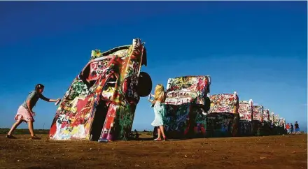  ?? Michael S. Williamson / Washington Post ?? It’s OK to add one’s own artistic mark at the famed Cadillac Ranch in Amarillo.