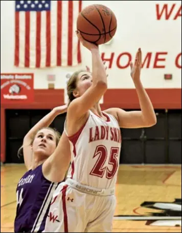  ?? Photo by John Zwez ?? Casey Minnig of Wapakoneta puts up a shot during Tuesday’s game against Fort Recovery. See more photos at wapakdaily­news. com.