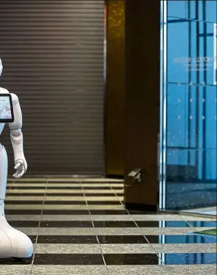  ??  ?? iting for guests at a hotel lobby in Tokyo, Japan. Will these robots ultimately orkers in hotels? — aFP