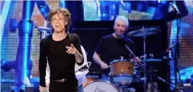  ?? Evan Agostini/Invision/AP ?? Mick Jagger, left, and Charlie Watts perform together in December 2012 in Newark, N.J. Rolling Stones bandmate Keith Richards says in his autobiogra­phy that Watts once caught Jagger with a right hook.