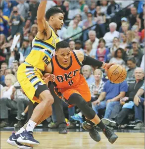  ?? CHRIS HUMPHREYS / USA TODAY ?? Oklahoma City Thunder’s Russell Westbrook drives to the basket against Gary Harris of the Denver Nuggets during the second half of OKC’s 106-105 victory at Pepsi Center in Denver, Colorado, on Sunday. Westbrook finished with 50 points, 15 rebounds and...