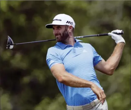  ?? DAVID J. PHILLIP — THE ASSOCIATED PRESS ?? Dustin Johnson hits a drive on the 12th hole during a practice round for the U.S. Open golf tournament Wednesday at Erin Hills in Erin, Wis.