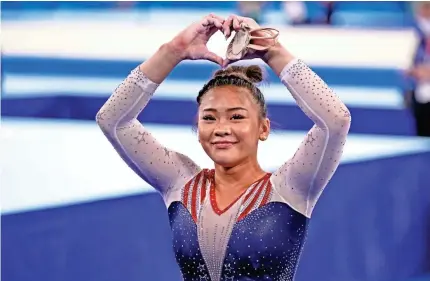  ?? DANIELLE PARHIZKARA­N/USA TODAY SPORTS ?? “This is such a surreal moment,” Suni Lee says after becoming an Olympic champion.