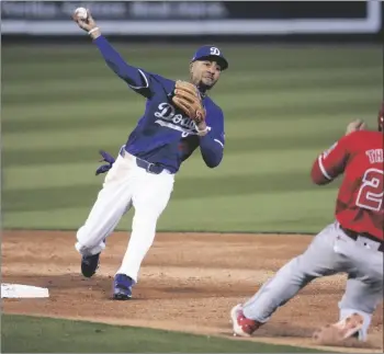  ?? AP PHOTO/ASHLEY LANDIS ?? Los Angeles Dodgers second baseman Mookie Betts (50) throws to first as Los Angeles Angels’ Zach Neto grounds in to a force out during the third inning of a spring training baseball game in Phoenix, on Tuesday.