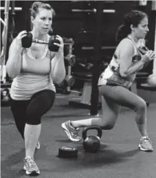  ?? Paul Aiken, Daily Camera file ?? Vicky Simmons, left, and Rachel Johnson do a set of curtsy lunges at Kaia Fit in Lafayette.