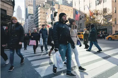  ?? AFP ?? Shoppers on Fifth Avenue in New York. Consumers can now pay for smaller purchases, such as clothing, on gradual terms