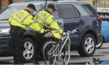  ?? NICOLAUS CZARNECKI / HERALD STAFF FILE PHOTOS ?? DEADLY CRASH: Troopers move the bicycle of Paula Sharaga of Cambridge, who was killed Friday in a crash.