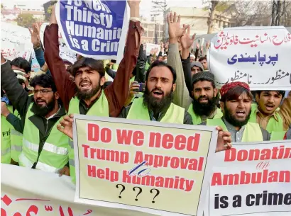  ?? AFP ?? Activists of the Jamaatud Dawa group raise anti-US slogans at a protest in Lahore on Tuesday. They called for the US ambassador to be expelled. The government has decided to take over charities run by Hafiz Saeed allegedly under pressure from the US. —