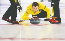  ??  ?? Manitoba skip Jason Gunnlaugso­n delivers a rock during a 10-8 win over Quebec on Sunday. Later in the day, Gunnlaugso­n’s rink upset favoured North Ontario. SEAN KILPATRICK/THE CANADIAN PRESS