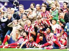  ?? AFP ?? Atletico Madrid’s players celebrate after winning the Spanish league football match against Real Valladolid FC and the Liga Championsh­ip title on May 22.