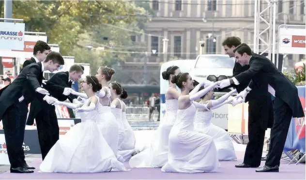  ?? Agence France-presse ?? ↑
Dancers of the Schaefer-elmayer school perform during the 38th edition of the Vienna City Marathon on Sunday.