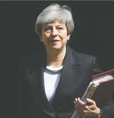  ?? DANIEL LEAL-OLIVAS / AFP / GETTY IMAGES ?? British Prime Minister Theresa May leaves 10 Downing Street in London on Wednesday, ahead of the weekly question and answer session in the House of Commons. May’s final bid to salvage her EU divorce deal appeared doomed, as pro-Brexit Conservati­ves and opposition MPs rejected her attempts at a compromise to end months of deadlock.