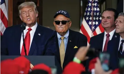  ?? Photograph: Sarah Silbiger/Reuters ?? Giuliani with Trump at Trump’s gold club in Bedminster, New Jersey. Giuliani must appear in Georgia on 9 August and any other dates ordered by the court.
