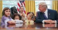  ?? PABLO MARTINEZ MONSIVAIS — THE ASSOCIATED PRESS ?? President Donald Trump meets with children dressed in their Halloween costumes in the Oval Office of the White House, Friday. The White House invited the children of members of the media to visit the president and to tricko-treat at the White House...