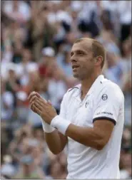  ?? TIM IRELAND — ASSOCIATED PRESS ?? Gilles Muller celebrates after beating Rafael Nadal on Day 7 at Wimbledon July 10.