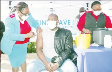  ??  ?? jab. ( RIGHT PIC) SNAT Secretary General Sikelela Dlamini receiving his COVID19 vaccine