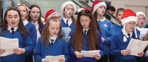  ??  ?? Pupils from St Oliver’s primary school singing carols in Scotch Hall.