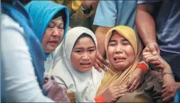  ?? HADI SUTRISNO / AFP ?? Family members of the crashed plane react at Pangkal Pinang airport in Bangka Belitung province.