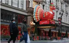  ?? Getty Images ?? SHORT ROUTE: Even the Macy’s Thanksgivi­ng Day Parade is cutting back on travel this year, operating only on the block in front of the Herald Square department store on Manhattan.