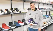  ??  ?? Outside the Box owner Angelo Bellucci poses in his newly opened store on the lower level of the Main Street Commons at 559 Main St. in Bethlehem. The store buys, sells and trades new and gently used men’s, women’s and children’s sneakers.