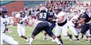  ?? / Contribute­d by Shelly Culver ?? Donte Williams (center) looks to make a tackle against Heard County during their first half at home.