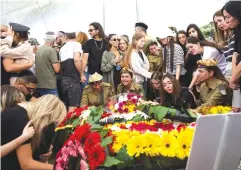  ?? (Shir Torem/Reuters) ?? FRIENDS AND FAMILY mourn Lia Ben-Nun, an IDF soldier who was killed by a member of the Egyptian security services along with two other soldiers near Israel’s border with Egypt, at her funeral in Rishon Lezion on Sunday.