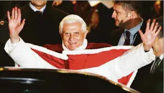  ?? Andrew Medichini / Associated Press file photo ?? Pope Benedict XVI waves after arriving at Istanbul's airport, Turkey, on Nov. 29, 2006. When Cardinal Joseph Ratzinger became Pope Benedict XVI and was thrust into the footsteps of his beloved and charismati­c predecesso­r, he said he felt a guillotine had come down on him. The Vatican announced Saturday that Benedict, the former Joseph Ratzinger, had died at age 95.