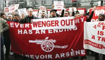  ?? IAN KINGTON/AFP ?? Arsenal supporters call for the end of the reign of their team’s manager Arsene Wenger, ahead of the English FA cup quarter final football match against Lincoln, at the Emirates Stadium on Saturday.