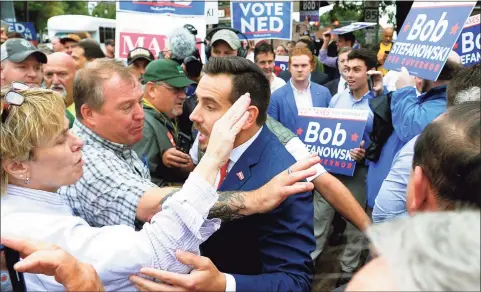  ?? Christian Abraham / Hearst Connecticu­t Media ?? Then-state Republican Chairman J.R. Romano, center, mixed it up with Ned Lamont supporters ahead of a debate for governor in 2018 in New London.