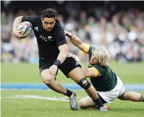  ?? — AP ?? DURBAN: New Zealand’s Anton Lienert-Brown, left, avoids a tackle by South Africa’s Faf de Klerk, during the rugby championsh­ip match between South Africa and New Zealand, at Kingsmead stadium in Durban, South Africa, Saturday.