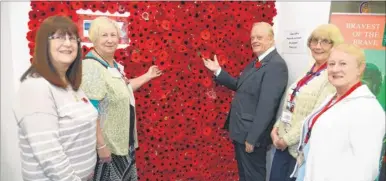  ?? Picture: Chris Davey ?? Jenny Hills, Carolyn Perring, Joyce Catt and Carol Johnson were among those who contribute­d to the poppy wall with Richard Cast, Kent chairman of the Royal British Legion