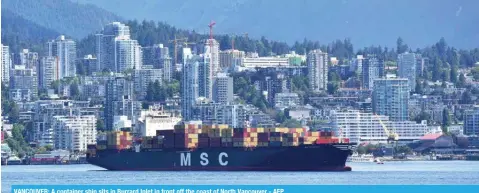  ?? AFP ?? VANCOUVER: A container ship sits in Burrard Inlet in front off the coast of North Vancouver.