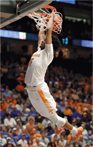  ??  ?? Tennessee’s Detrick Mostella dunks during Wednesday night’s game against Auburn at the Southeaste­rn Conference tournament in Nashville. The Vols handled Auburn easily in a 97-59 victory.