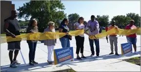  ?? PHOTOS BY SHEENA HOLLAND DOLAN — THE NEWS-HERALD ?? Mayor Kirsten Holzheimer Gail (middle) and Euclid resident Albert Hardin (middle with scissors) cut the grand opening ribbon on the new Bluestone basketball courts, joined by some other members of the team who made the vision a reality.