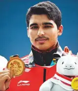  ?? AP ?? India’s Saurabh Chaudhary celebrates with his gold medal during the 10-metre air pistol men’s awards ceremony.