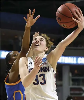  ??  ?? Connecticu­t's Katie Lou Samuelson shoots as UCLA's Kennedy Burke (left) defends during the second half of a regional semifinal game in the NCAA women's college basketball tournament Saturday in Bridgeport, Conn. AP PHOTO