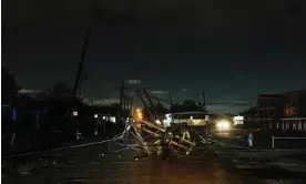  ?? Photograph: Christiana Botic/EPA ?? Downed lines and utility poles block roads after a tornado in Harvey, Louisiana Wednesday.